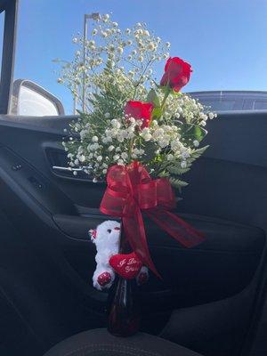 2 rose arrangement in a vase with a bow and bear