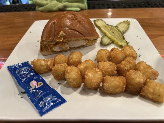 Chicken Sandwich in half with tater tots