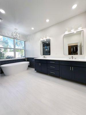 Dual vanity by Pro Work USA: navy cabinets, quartz countertops, modern mirrors, and towel warmer. Sleek, functional, and stylish design.