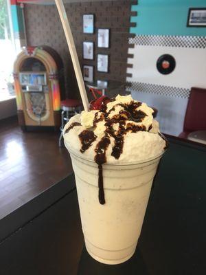 Old fashioned vanilla ice cream soda with whipped cream and a cherry on top