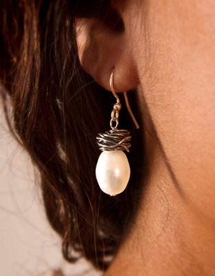 Handwrapped and antiqued Sterling silver knot with freshwater pearl earring. Matching necklace available.