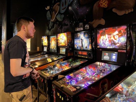 Upstairs pinball machines, (off camera is skeeball, basketball, arcade games, a bar and dining area)