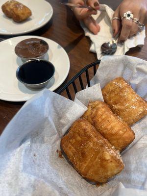 Croissant Beignets. Comes with 8 tossed in sugar, served with a choice of raspberry sauce, nutella, or caramel.