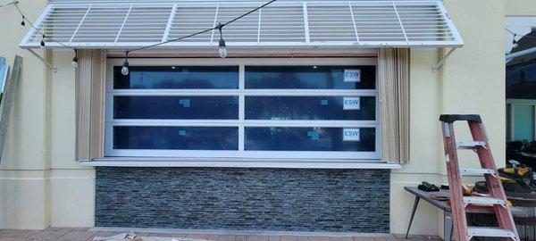 ES Glass Garage Door.  Anodized frame, gray tint glass.