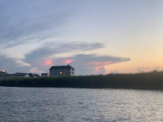 Sunset with a cloud that resembles a giant blue crab with red eyes.