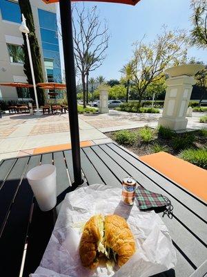 Clean, cute, and really peaceful outside sitting area. + Veggie Breakfast Croissant