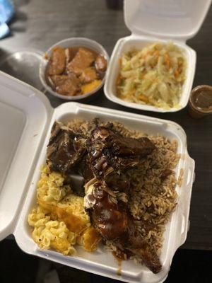 Large Jerk Chicken Platter: baled macaroni and cheese, rice and peas w/ oxtail gravy, cabbage and yams.