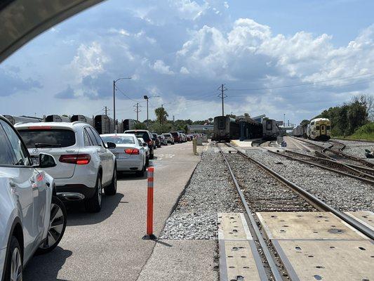 There can be a long line.  If you approach station from the wrong direction, Just keep driving by make a U-turn and join the line!