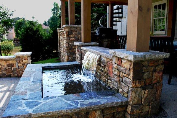 Outdoor living area and masonry pond