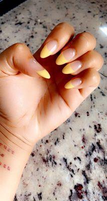 Yellow French tips, almond shape.