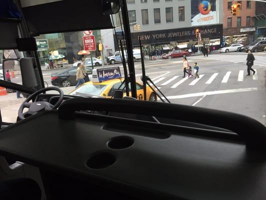 First row on this bus has a desk area with outlets.