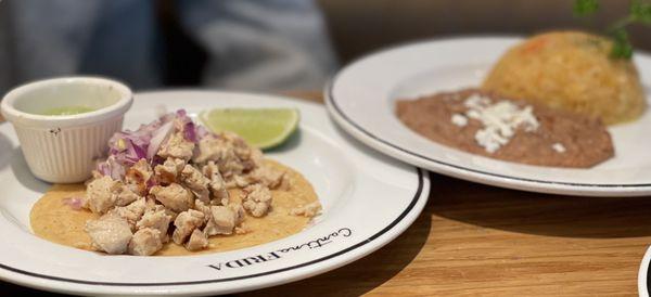 Chicken tacos with a side of rice and beans