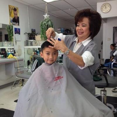 kid friendly shop.  Happy kid getting a haircut by Lynn