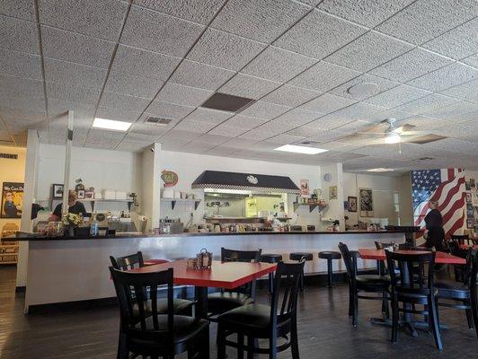 Interior photo of the dining area and kitchen and counter.