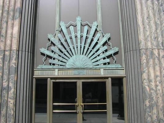 Main Entrance. The patina on the sunburst sculpture has been polished off and the sculpture is now shiny.