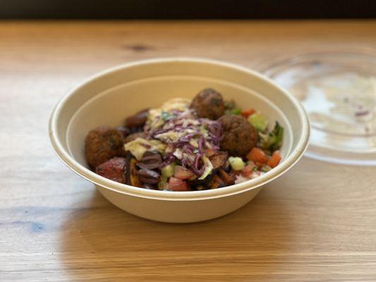 Roasted vegetables and sweet potatoes with extra falafel on brown rice and lentils