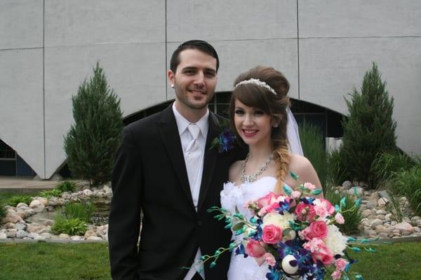 Lovely waterfall makes a perfect backdrop for the bride and groom.