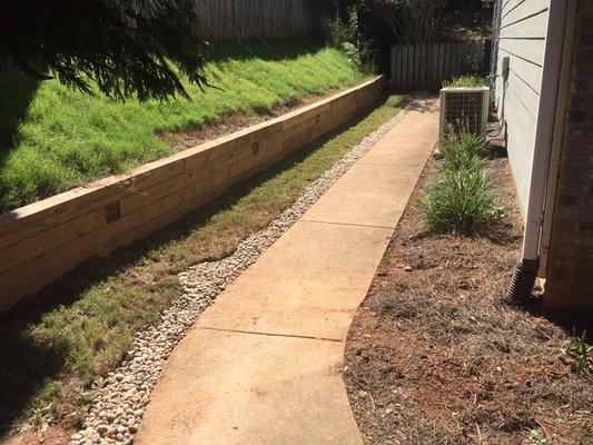 Then we covered the drain with pond stones. Now water can go into the drain system and away from the home.