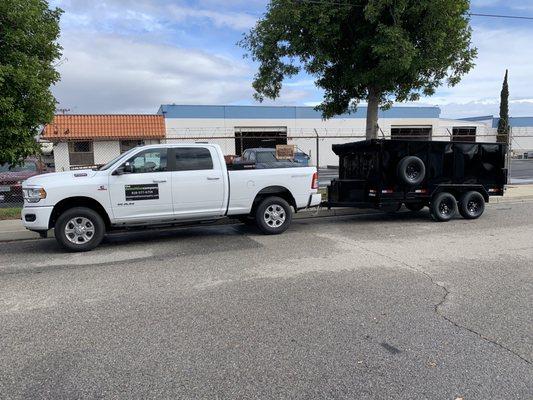 Black High Side with tarp roller and spare tire and wheel.