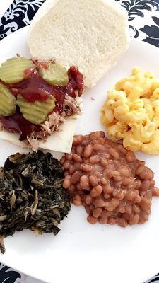 Pulled pork Sandwich with greens, baked beans, and macaroni. (I added pickles and cheese)