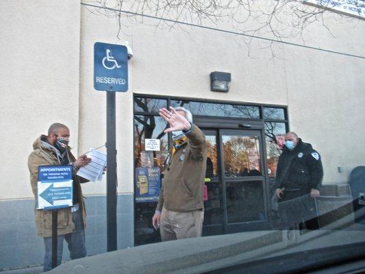 blocking me from photographing his face after illegally harassing me and turning me away because of my Assistance Dog