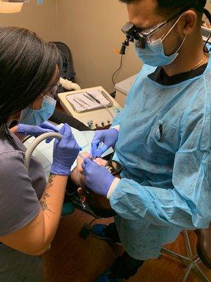 Dr. Patel and dental assistant Jaleesa Jones perform deep cleaning on patient.