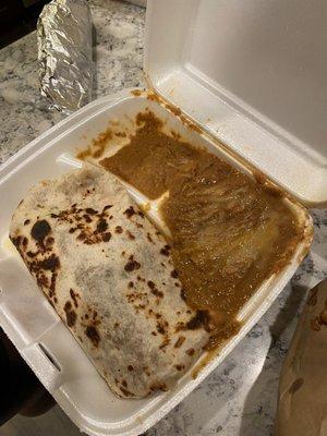 Burrito with what looks like canned refried beans next to it. Food was extremely cold.