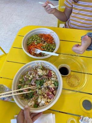 Tuna poke bowl with rice, cilantro, red onions, corn, and edamame. Kids poke bowl with rice, chicken, edamame, and carrots.