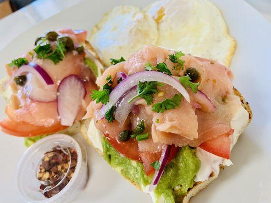 Avocado toast with smoked salmon, red onions, capers, tomatoes and cream cheese