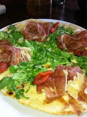 Grilled flatbread with prosciutto and arugula