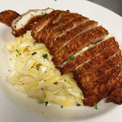 Fettuccini Alfredo topped with breaded chicken