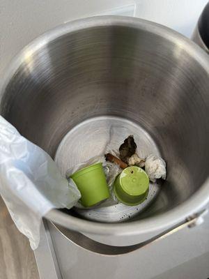 Garbage and cigarette butts in ice bucket from previous guest