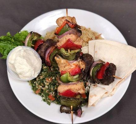 Lebanese plate - two kebabs, almond rice pilaf, tabbouleh, flat bread, garlic sauce.