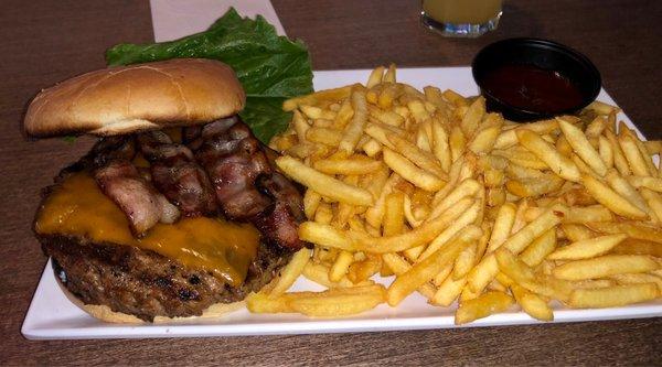 Burger with side of fries, veggies on the side