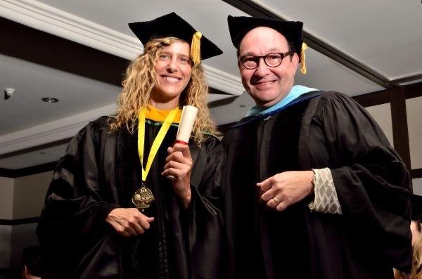 Student receiving her diploma.