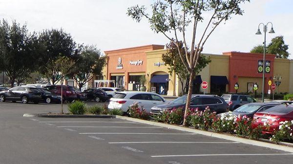 The many retail stores that you can find when you arrive in one big parking lot area .