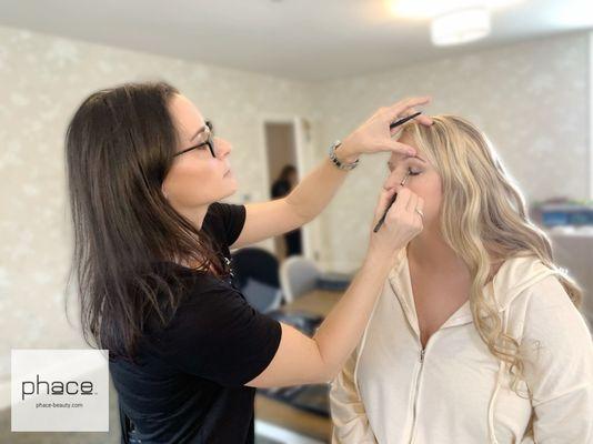 Andrea doing bridal makeup.