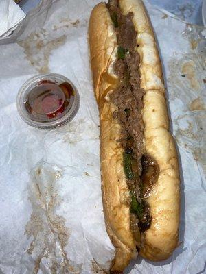 Cheesesteak with onions, peppers and mushrooms and a side of cherry peppers