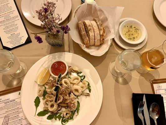 Beautiful spread with calamari bread, dipping oil, and drinks