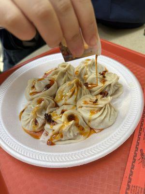 Soup dumplings drizzled with chili oil -- an absolute shame that the service is bad