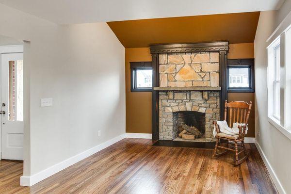 Whole Home Renovation, Den: New paint, floor refinishing, new windows, all new custom trim, accent lighting behind new fireplace wall trim.