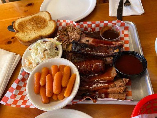 4 meat combo pulled pork, smoked sausage, ribs, brisket with 2 sides carrots and coleslaw.