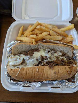 Philly steak sandwich and fries