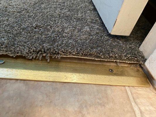 Trim was installed incorrectly, not covering the carpet