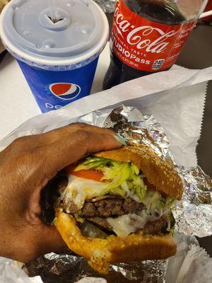 Double Swiss cheeseburger. Coke. Pepsi ice cup.