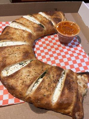 Delicious calzone with spinach, broccoli and caramelized onions. Yummy.