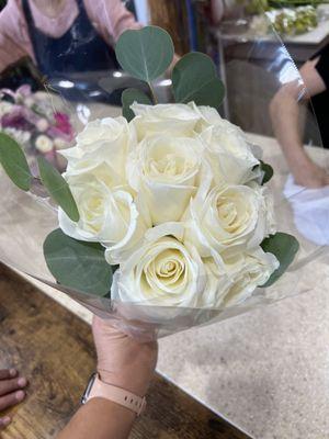 $100 for 10 white roses with a little "green"