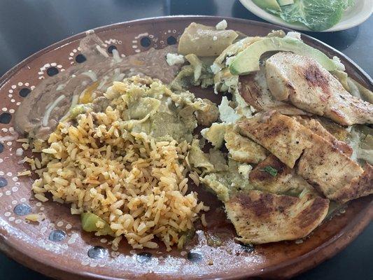 Chilaquiles verdes with rice and beans. Chicken and avocado were extra. The salsa is incredible and I will definitely be back for more.