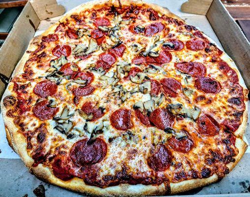 Large pepperoni and mushrooms pizza.