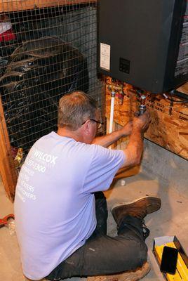 Jerry is connecting Scale Guard kit on a tankless water heater to protect the tank from scale and minimize required maintenance.  Tankless